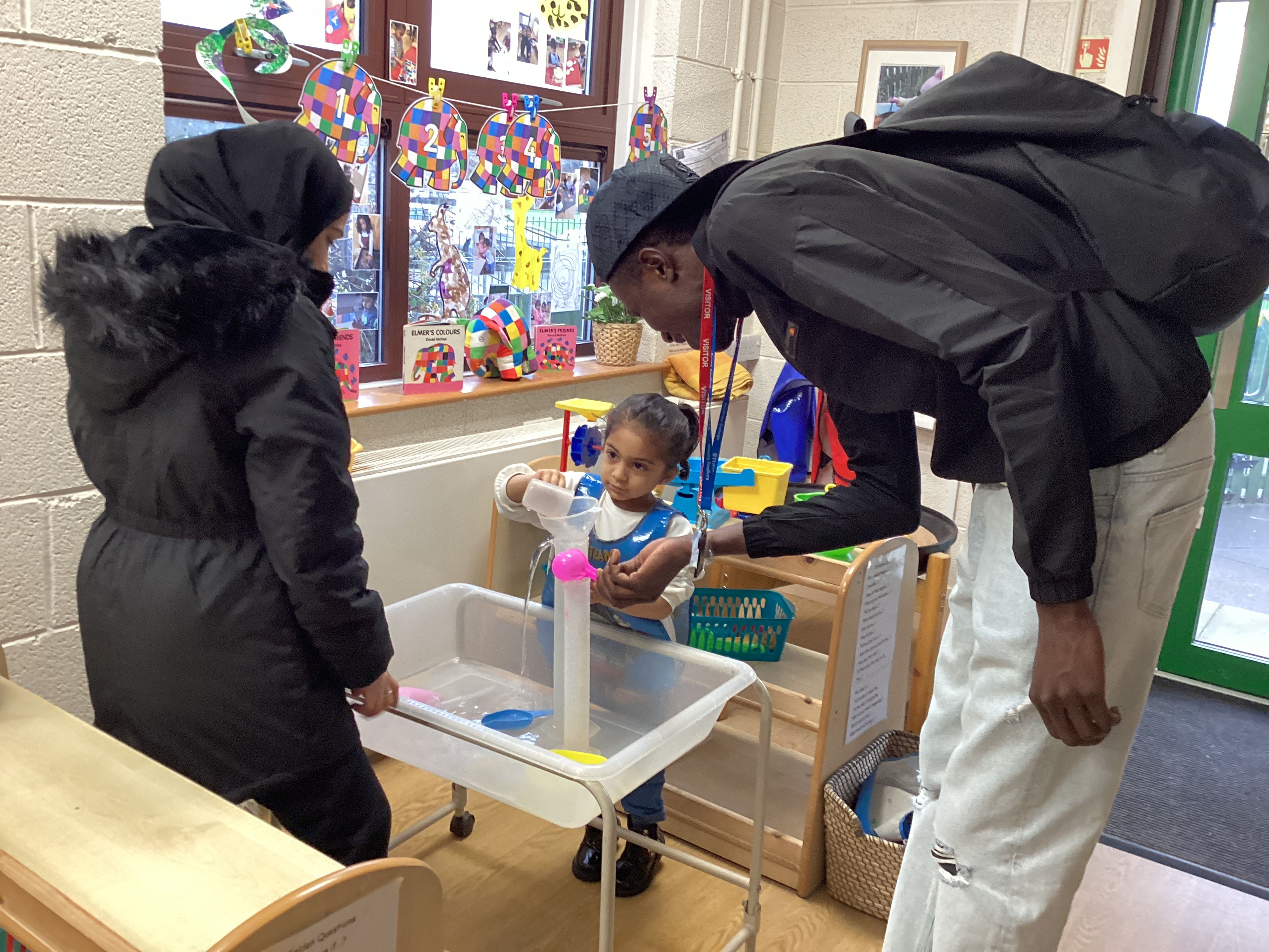 ESOL student and primary school aged girl working together