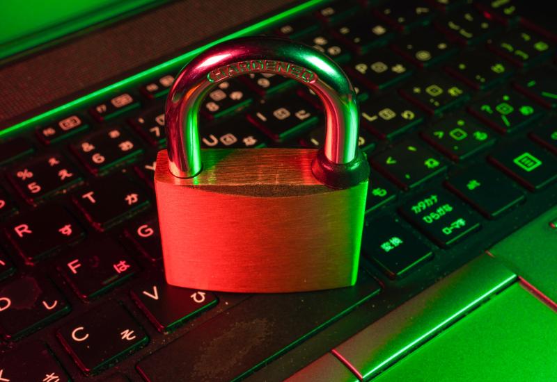 This photo shows a closed padlock resting on a computer keyboard.